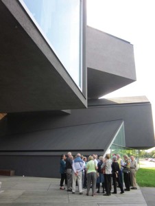 Trust members explored the Vitra Design Museum in Weil am Rhein, Germany. They are standing in front of Vitra Haus, designed by Herzog & de Meuron and housing the modern Vitra home collection of furniture.