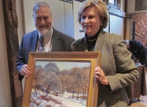 Jonathan Fairbanks, past president of the Trust and artist, presented Penny Hunt with his painting of the woods behind his house.