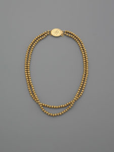 Locket and Beads, engraved “HP” for Hannah Pelletreau, Elias Pelletreau, ca. 1775–1790, gold, string. Courtesy Yale University Art Gallery