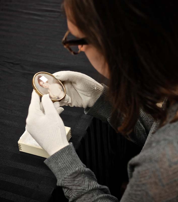 Examining a miniature during full-access tours of MESDA.