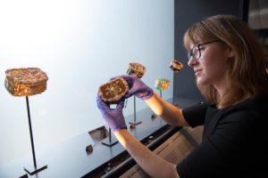 Dr Heike Zech, the V&A's Senior Curator of the Rosalinde and Arthur Gilbert Collection, installing bejeweled snuffboxes that once belonged to Frederick the Great of Prussia. Photo © Victoria and Albert Museum