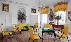 Chippendale-made armchairs and card tables are complemented by Alexander Peter's camelback sofa in the Dumfries House Family Parlor.