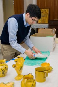 Daniel examines newly acquired pieces of English yellow-glazed earthenware.