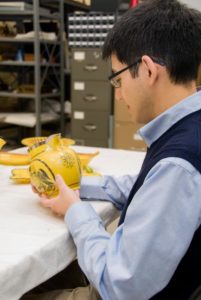 Daniel examines newly acquired pieces of English yellow-glazed earthenware.