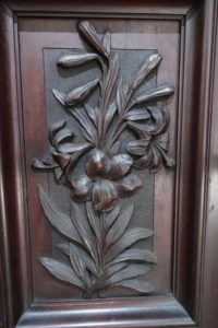 Carved detail of daylilies on the Fry sideboard