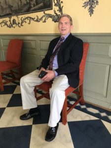 Figure 3. Robert McArtor of Wilmington, NC, enjoys the reproduction back stools in the Entry Hall.