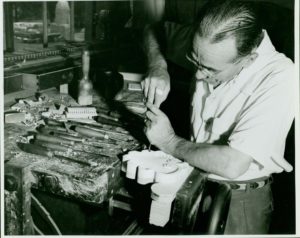 LOME: A Kaplan Furniture Company craftsman carves details into an ornamental furniture feature, 1924. Courtesy, The Joseph Downs Collection of Manuscripts and Printed Ephemera, Winterthur Museum.