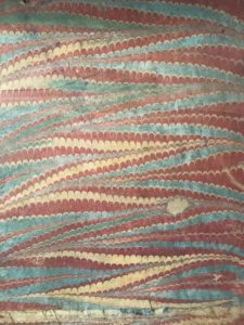 The marbled paper lining of a linen press tray at Nostell Priory.