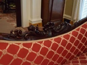 The carved crest rail of a sofa at the Andrew Low House