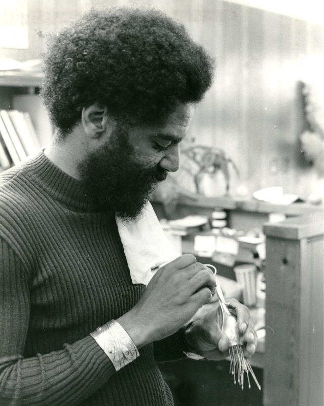Lamar Gayles will research the work of 20th-century Black American craftspersons. Pictured: Bob Jefferson at his 1972 bench in the Oakland area refining his jewelry.
