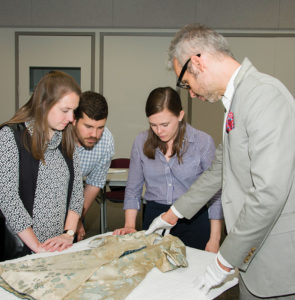 Catherine Cyr (center right) examines a frock coat with Curator of Textiles Ned Lazaro during Historic Deerfield’s Summer Fellowship program. Catherine received the Trust’s scholarship to attend the program in 2018.
