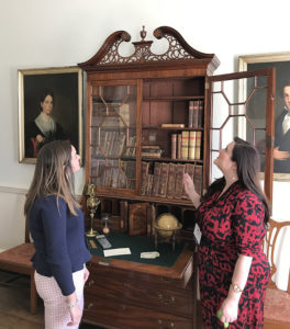 Rachel Lovett, Curator at the Hammond-Harwood House, discusses a John Shaw desk with Bethany McGlyn, Curtis Scholarship Recipient from the Winterthur Program.