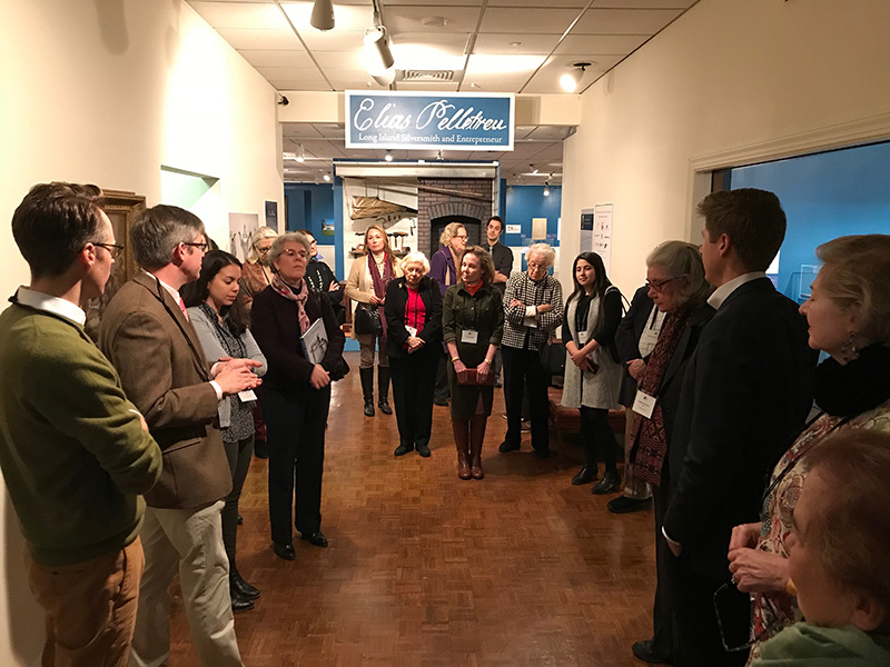 Trust members enjoy a curator-lead tour of the Elias Pelletreau exhibition at the Long Island Museum.