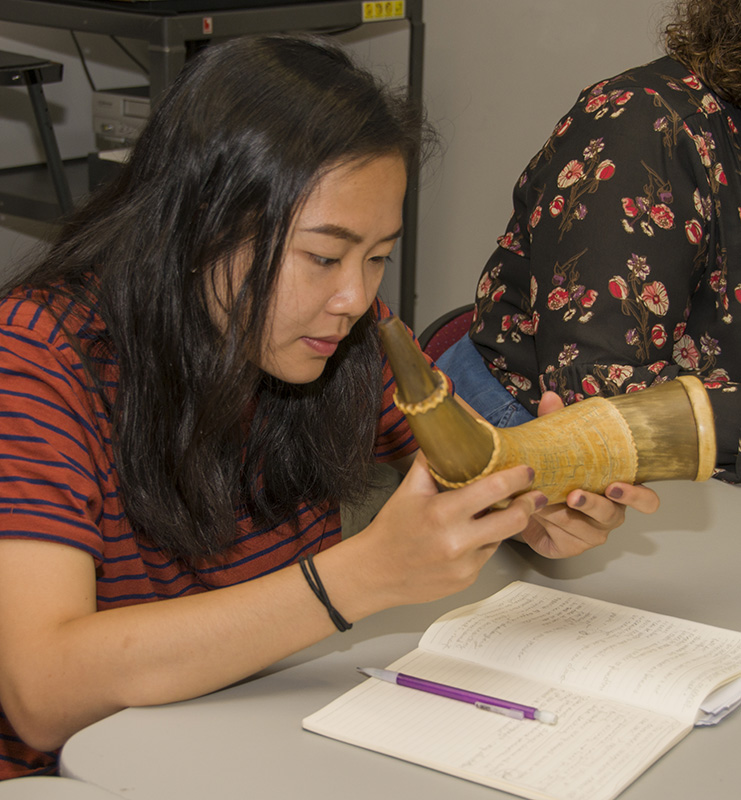 Tammy Hong examines a powder horn during Historic Deerfield’s Summer Fellowship.