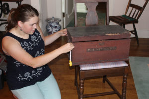Candice Candeto measures the traveling desk of Natchez, MS, cabinetmaker Robert Stewart.