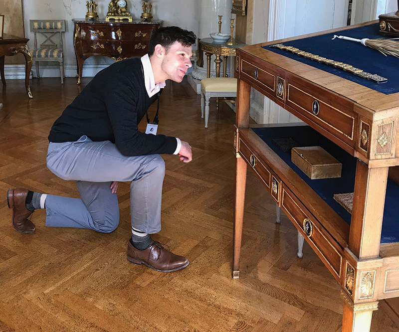 Trevor Brant studies a Gustavian desk during the Study Trip Abroad to Sweden and Denmark.