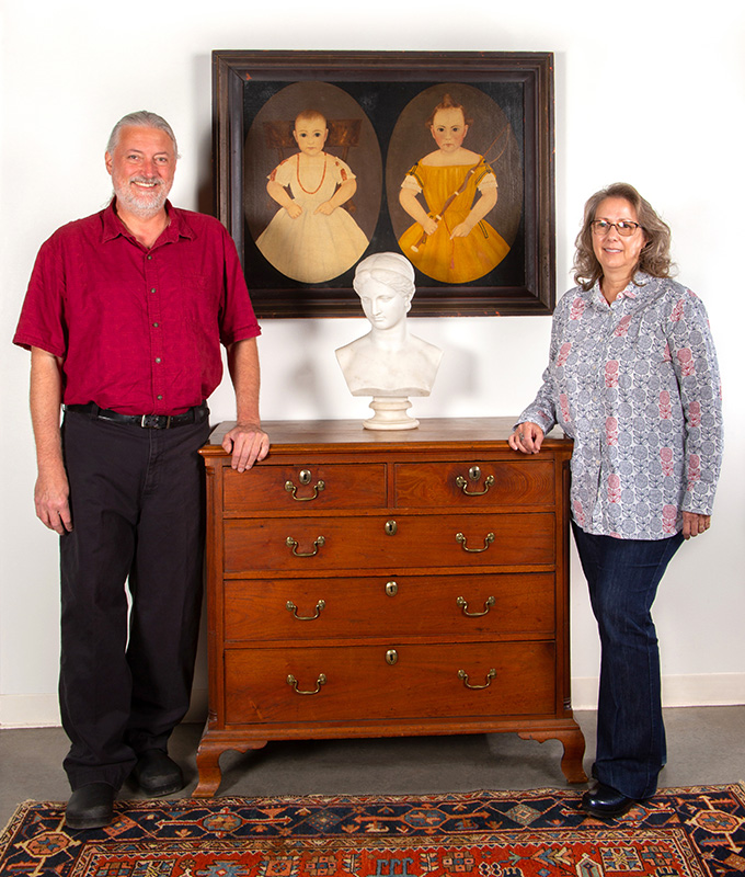 Jeffrey S. Evans and Beverley A. Evans, pictured with the John James Trumbull Arnold Double Portrait, a Lawrence MacDonald carved marble bust of Psyche or Diana, and a Winchester, VA Chippendale walnut chest of drawers.