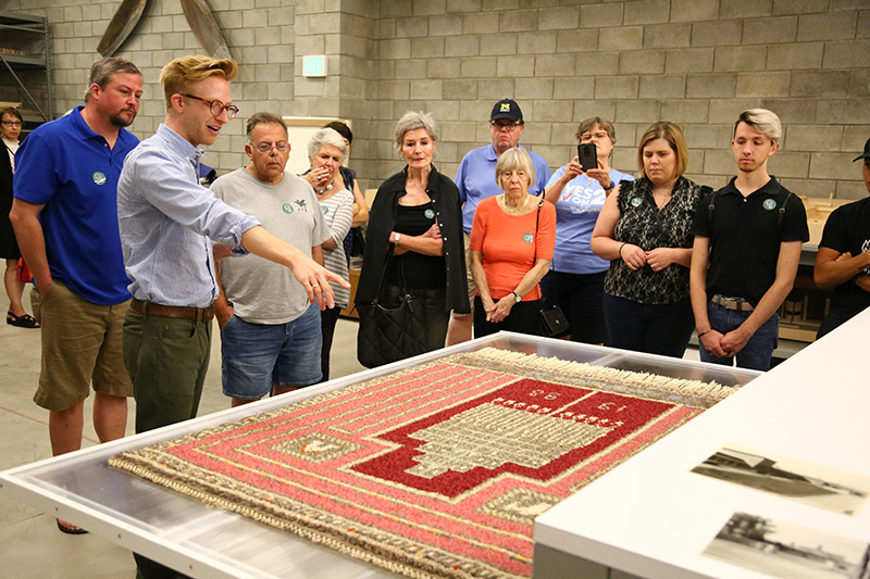 2016-2019 Center Collections Fellow Kevin Adkisson discusses “Cranbrook Rug No. 1” (1928) by Studio Loja Saarinen in the Cranbrook Art Museum Collections Wing, September 16, 2018. Jin Kim, photographer. Courtesy Cranbrook Center Center for Collections and Research.