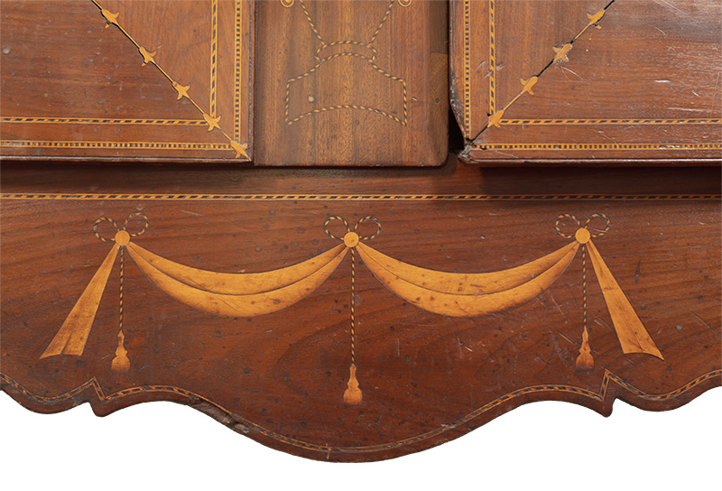 Detail of the Butterfly Man armoire seen above showing the tassel, swags, and banding found on the scalloped skirt.
