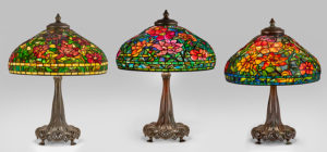 Figure 3. Group of three Peony lamps: one authentic example (center) by Tiffany Studios, c. 1905; two forgeries (left and right) by unknown maker(s), 1970s. Leaded glass, patinated bronze.