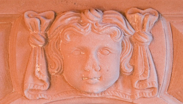 Detail of red-stone mantel.