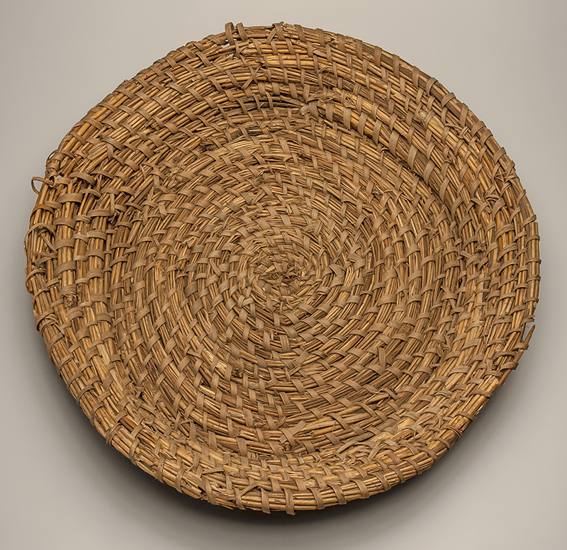 Figure 4. Now-unknown enslaved woman, Rice Fanning Basket, 1850–1860, Cat Island Plantation, Orangeburg County, SC. Rush, split white oak. MESDA. Courtesy of the Charleston Museum, 5764.1.
