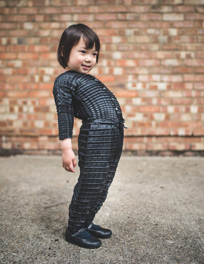 Ryan Mario Yasin’s pleated Petit Pli garments are designed to grow with their young wearers. Image courtesy Petit Pli.