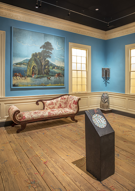 Figure 1. The White Hall dining room at MESDA with works by David Hammons, Theaster Gates, and Renée Green, exhibited alongside a jar by free Black potter David Jarbour. Loans courtesy The Hudgins Family Collection of New York, Theaster Gates, and The Fabric Workshop and Museum.