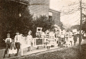 Figure 2. Children carrying box furniture out of the Home Thrift Association workshop, which was located in the Archibald Gracie Mansion on East 88th Street & East End Avenue in New York City. Courtesy Winterthur Library.