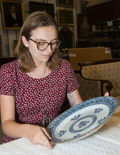 Mary Orms studies a ceramic platter in the Historic Deerfield conservation lab.