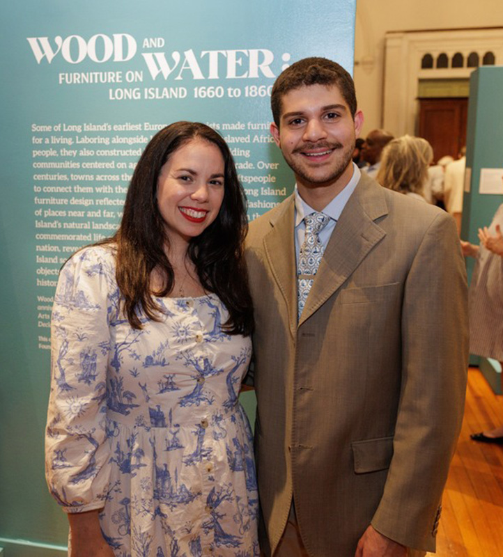 From left to right: Lauren Brincat, PLI’s Chief Curator & Director of Collections, and Steven Baltsas at the opening of Wood and Water: Furniture on Long Island, 1660–1860 in July 2026. Photo by Pineapple Shirt Productions.