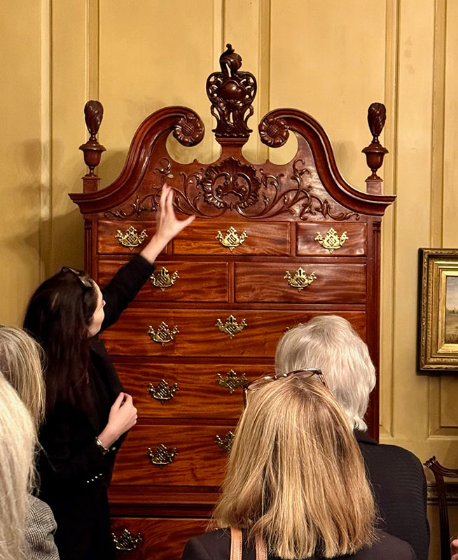 Figure 1. Virginia B. Hart discusses the applied carving on a Philadelphia high chest (1755–75) attributed to Nicholas Bernard.