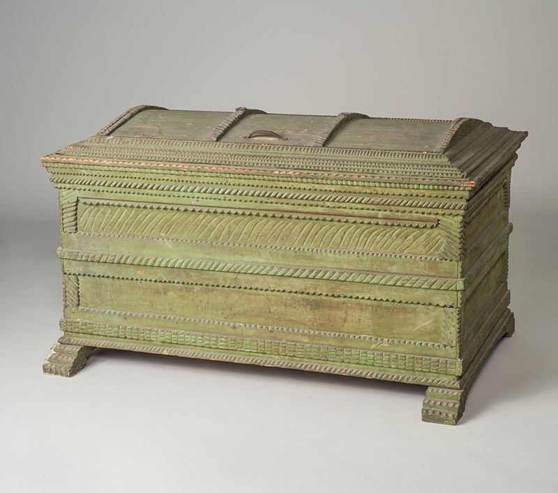 Neil Grasty is studying Black craftspeople represented in the High Museum’s collection, focusing on a blanket chest possibly by Brooks Thompson, 1900–1920. Painted yellow pine and cedar with iron fittings. High Museum of Art, Purchase with funds from the Decorative Arts Acquisition Endowment, 1991.284.