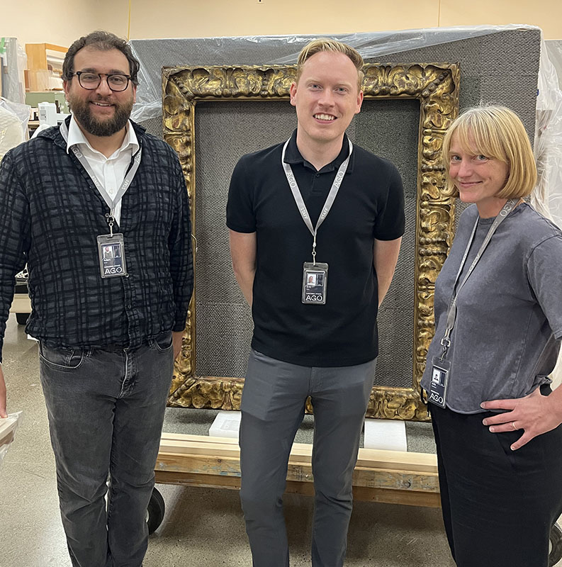 Figure 1. From left to right: Adam Harris Levine, Associate Curator, European Art; Eric Birkle, Marie Zimmermann Curatorial Fellow, European Art; and Julia Campbell-Such, Assistant Conservator, Frames, posing before an Italian frame (Art Gallery of Ontario, 97/392). Photo © AGO.