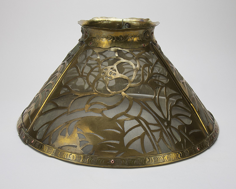 Elizabeth Goelet Rogers; Lamp shade with magnolia design, 1902. Newcomb College Pottery, New Orleans, LA. Brass and copper. Newcomb Art Museum, 1973.125.b-D&MA.