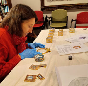 Figure 1. The author handles mother-of-pearl objects at The Metropolitan Museum of Art. Photo courtesy Emma Piercy-Wright.