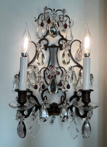 Figure 3. Electric sconce with back in the shape of a lyre, c. 1920s. Crystal, amethyst, bronze. Image courtesy of Nemours Estate.