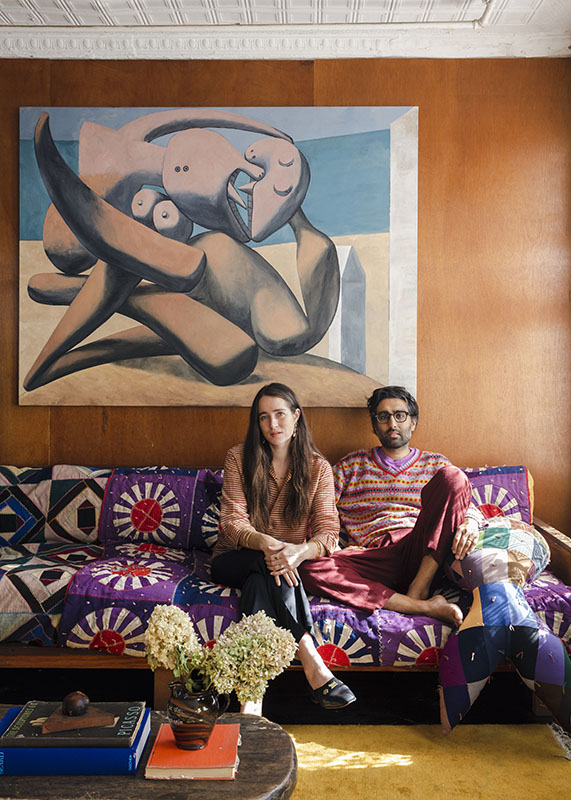 Emily Bode Aujla and Aaron Singh Aujla on a patchwork quilt-upholstered sofa in their loft in New York CIty’s Chinatown. Photo by Brian W. Ferry.