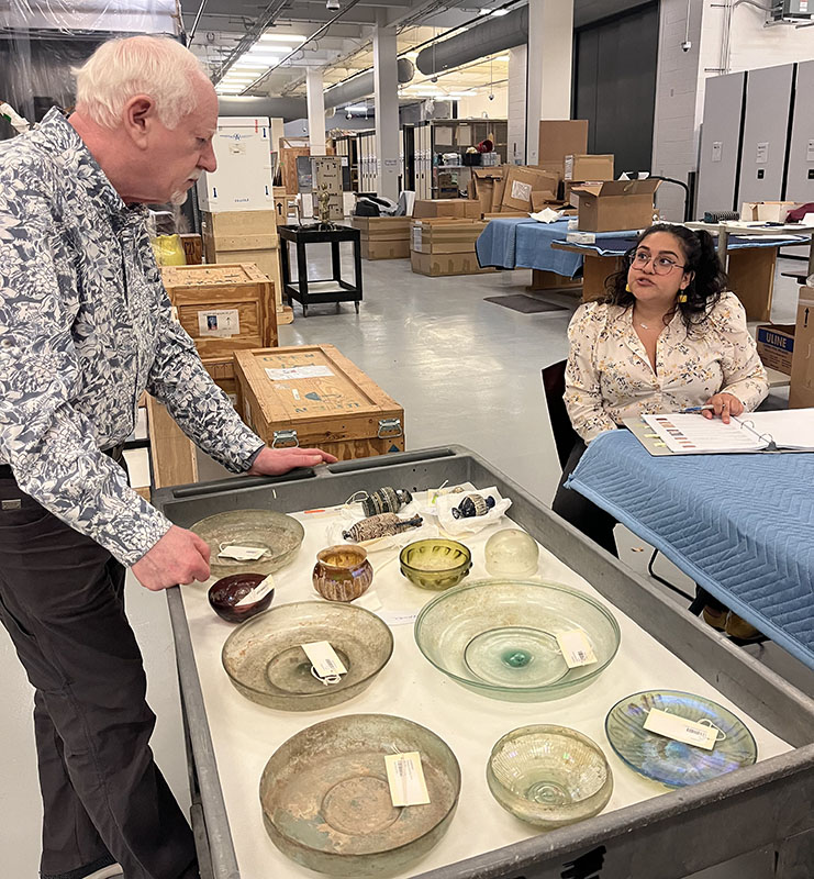 Figure 5. Laura Ochoa Rincon examining NOMA’s ancient glass collection with Sidney Goldstein, Emeritus Curator of Ancient & Islamic Art, St. Louis Art Museum, August 2023. Image courtesy the New Orleans Museum of Art (NOMA).