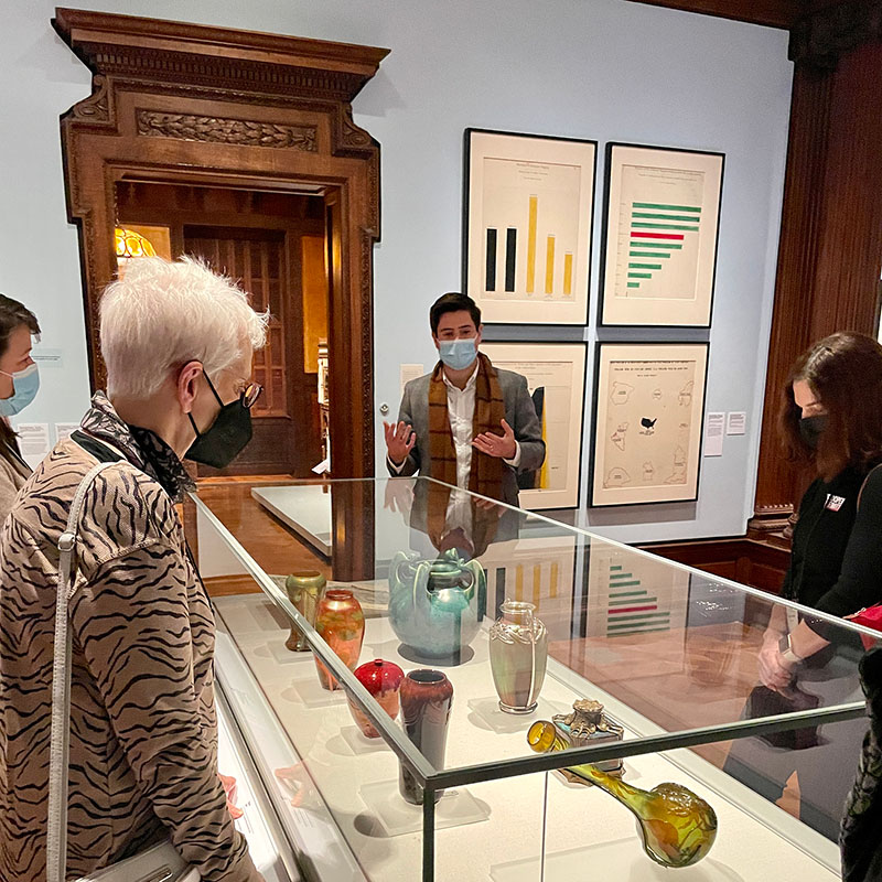 Devon Zimmerman, Associate Curator of Modern and Contemporary Art at the Ogunquit Museum of American Art (center) discussing case objects in relationship to Du Bois prints.