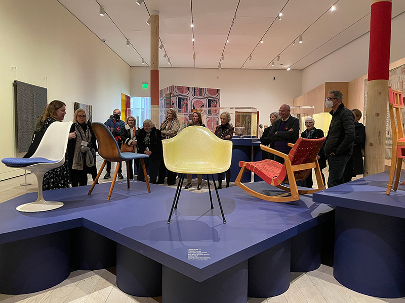 Figure 1. Decorative Arts Trust members enjoy the exhibition at LACMA with Bobbye Tigerman. Shown at center front is Charles and Ray Eames’s DAX chair, Herman Miller Furniture Company, 1948-50. Fiberglass, steel, rubber. LACMA, purchased with funds provided by Alice and Nahum Lainer, M.2010.13.