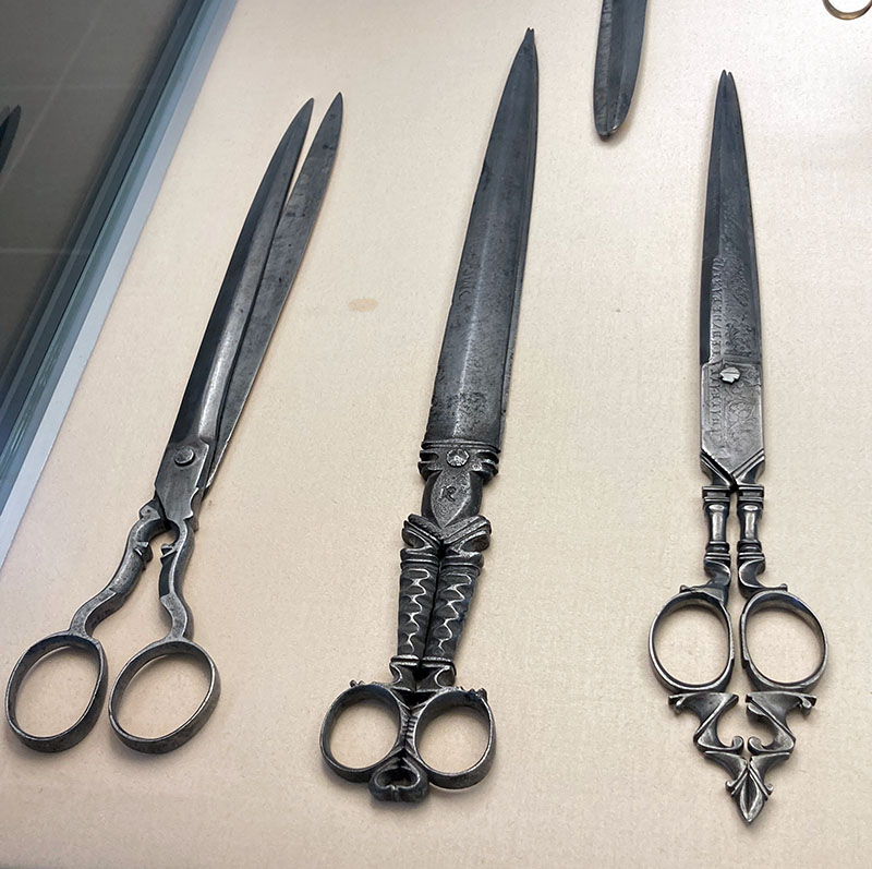 Figures 1–3. Scissors, mid-17th century, Spain (likely Albacete). Steel. Deutsches Klingenmuseum. Photo by author. Note the simple design on figure 1, versus the more complex designs on figure 2 and 3, especially the etched blades on the latter.