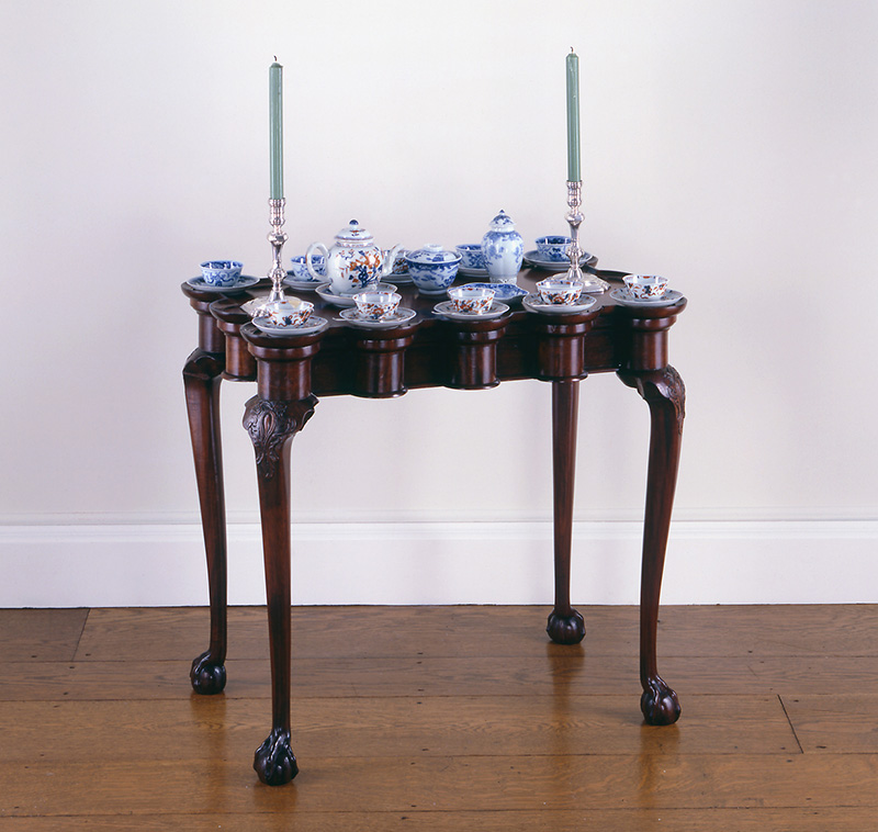 Tea table, 1745–65, Boston, MA. Mahogany, pine. Bequest of Henry Francis du Pont, 1958.2774. Teapot, Tea canister (Tea bottle) Sugar bowl, Dish (Stand), Teabowls (Teacups), Saucers, 1740–60, Jingdezhen, China. Porcelain (hard-paste), lime (alkaline) glaze. 1979.0114 A, B; 1959.0077.023 A, B; 1959.0077.022 A, B; 1959.0077.024; 1959.0077.001; 1959.0077.007; 1959.0077.013; 1959.0077.017. John Burt, Candlesticks, 1720–30, Boston, MA. Silver. 1979.0114. Image courtesy Winterthur, photo by Gavin Ashworth.