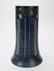 Figure 4. Newcomb College Pottery; Roberta Beverly Kennon (1877–1931), decorator; Vase with pine forest design, 1905. Earthenware with underglaze polychrome ornament. Newcomb Art Museum, 1982.425-C.
