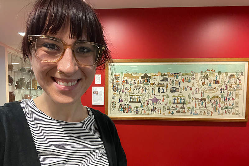 Figure 1. The author in front of an untitled embroidery by Ethel Wright Mohamed commissioned for the 1976 Festival of American Folklife, made c. 1975-6. Material Culture Collection, Smithsonian Center for Folklife and Cultural Heritage, MCC 211. Photo by the author.